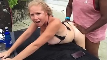Mature on the beach while husband films