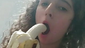 Teen cuties sucking a banana like a hard cock